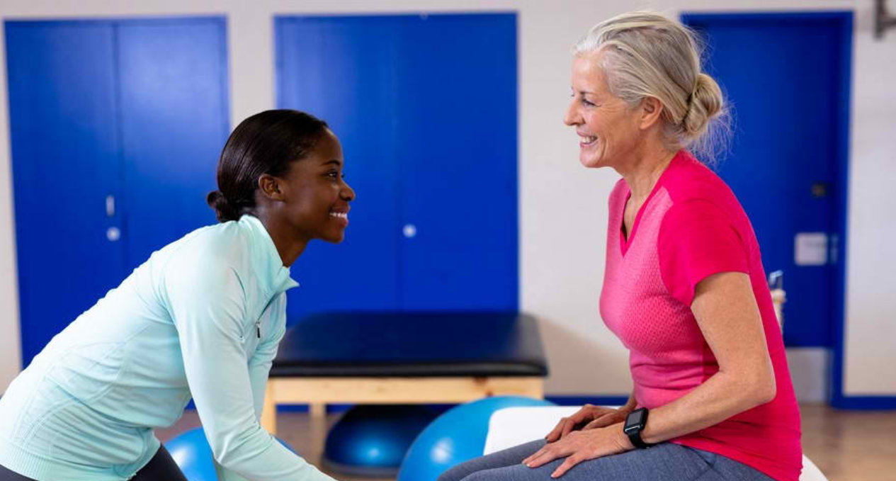 african woman therapist assisting the old lady