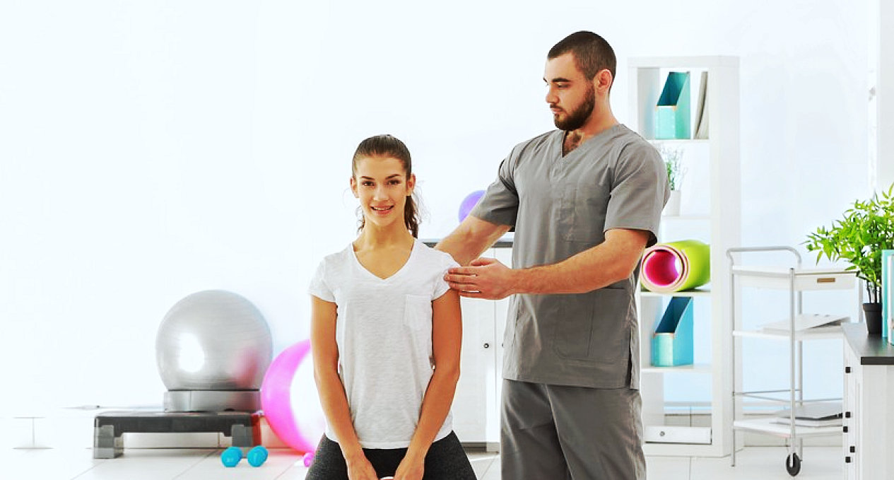 young male therapist instructing the young lady